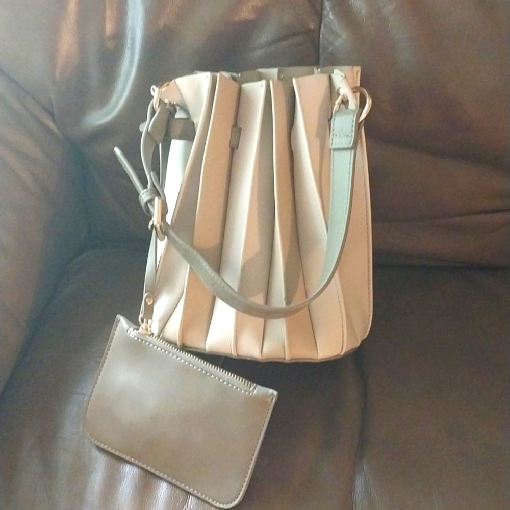 Pleated leather specialty store bucket bag with wallet and extra wallet strap.